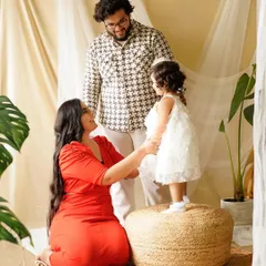 A beautiful interaction as this little girl stands on the pouf to connect with her parents. Our studio setups are designed to encourage natural family moments.