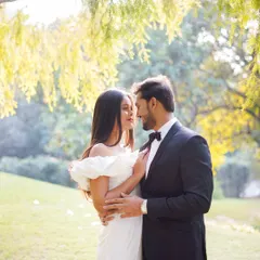 A romantic portrait under the soft, filtered light of willow trees. This kind of natural setting provides a beautiful, serene backdrop for couple photography.