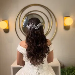 I love creating elegant hairstyles for white weddings. Here, I styled the bride's hair in soft, flowing curls and finished it with a delicate, sparkling hair vine for a touch of classic romance.