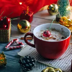 Another angle of the Christmas coffee scene, focusing on the red mug and festive props. The composition feels cozy and full of holiday cheer.