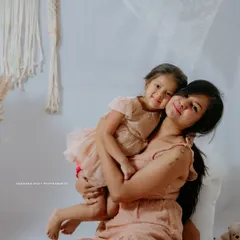 There's a special bond between a mother and her child, and I aim to capture that warmth in my Mom & Me sessions. This studio portrait uses a soft, bohemian-inspired theme with neutral tones to create a gentle and loving atmosphere.