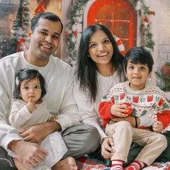 A joyful family Christmas portrait. Coordinating outfits and happy smiles make for the perfect holiday photo.