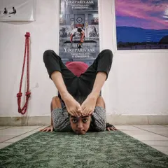 Our advanced batches prepare students for yoga competitions. This student is practicing a complex forward bend, showcasing focus and control.