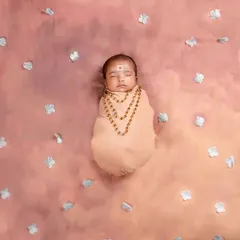 Celebrating Vinayagar Chathurthi with our littlest devotee. This newborn is peacefully swaddled, embodying the blessings and innocence of the auspicious occasion.