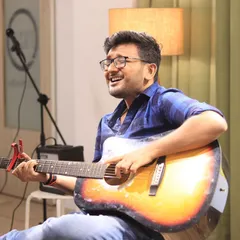 Strumming the chords of the soul. An artist captivates the audience with a heartfelt musical performance during a "Speaking Souls" open mic night at our studio.