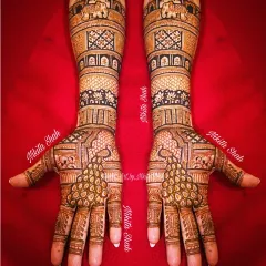 An elbow length Indian mehendi for the bride's Chachi. This design is rich with traditional motifs like peacocks and elephants, perfect for wedding festivities.