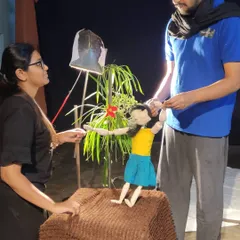 Our team works together to set up a scene for a new project. This shows the collaboration that goes into every performance, from lighting to puppet manipulation.
