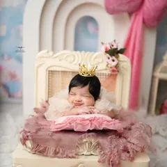 A tiny princess dreaming sweet dreams. This image captures the pure innocence I aim for in my posed newborn sessions, complete with a delicate crown and the softest smile.