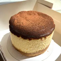 A classic, reimagined. Our eggless New York Chocolate Cheesecake is rich, creamy, and has a perfectly baked top dusted with cocoa powder.