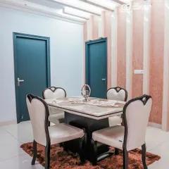This dining space combines elegance and modernity. I used a classic four-seater dining table and paired it with a textured, striped pink wallpaper and contemporary ceiling lights to create a warm and inviting atmosphere.