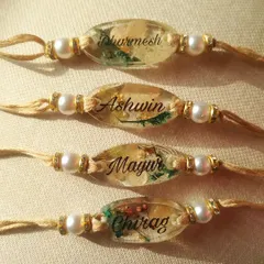 Here is a batch of personalized name rakhis I created for a single order, with the names Dharmesh, Ashwin, Mayur, and Chirag. Each one is unique, with different arrangements of preserved botanicals and gold flakes inside the clear resin.