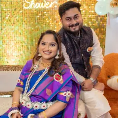 A happy couple at their baby shower. Her makeup is bright and celebratory, perfect for this joyous milestone.