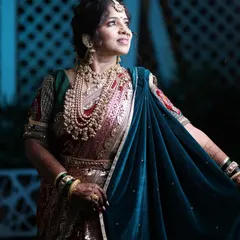 A stunning nighttime shot of a client in a bridal Nauvari, complete with a velvet shela (dupatta).