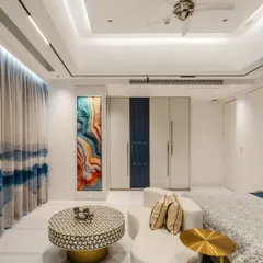 This angle highlights the vibrant abstract art piece, which adds a splash of color and personality. The custom wardrobe with its blue panel and sleek handles integrates seamlessly into the design.