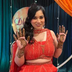 The joy on a client's face is the best feedback. She is happily showing both her hands, adorned with matching peacock designs for her sangeet ceremony.