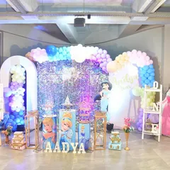 A dream come true for any princess fan. This setup includes a sparkling sequin backdrop, character cutouts of famous princesses, and custom-printed pedestals for the cake and desserts.