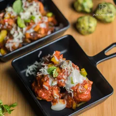 A close-up shot of a delicious appetizer served in a miniature black skillet, showcasing my modern plating style.