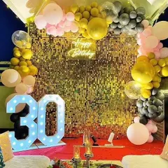 This 30th birthday party features a stunning gold sequin wall that really shines. The balloon arch in black, gold, and pink adds a touch of modern elegance.