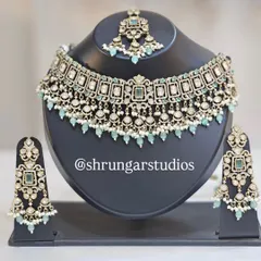 A full view of our popular mint green Kundan bridal set, including the choker necklace, matching oversized earrings, and a maang tikka.