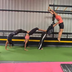 Time to pose in a different way. Our adult students having fun with an acro yoga pose, showcasing their strength and teamwork.