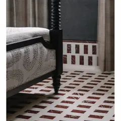 In the 'Aria' master bedroom, we crafted this beautiful in-situ flooring from IPS and marble. The geometric pattern provides a stunning base for the classic black four-poster bed, showcasing our belief that every surface, even the floor, is an opportunity for design.