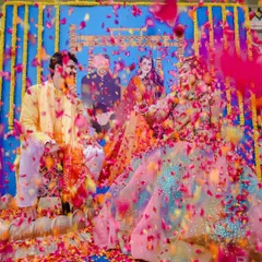 The pure, unadulterated joy of a Haldi ceremony. This shot, with a shower of vibrant flower petals, captures the energy and color that make Indian pre-wedding rituals so special and memorable.