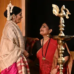 Sharing a light moment on stage with senior dancer Madhavi Mudgal during the Upasana Samman ceremony.