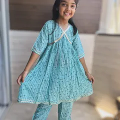 I believe traditional wear should be full of grace, not restrictions. This light and airy blue Angarkha set is made from pure cotton, allowing for endless twirls and happy giggles. The delicate gold detailing adds just the right amount of festive sparkle.