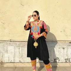 Here’s a full look featuring the golden potli. It complements the rich colors and intricate embroidery of the black kurta set, making it an ideal choice for a sangeet or festive party.