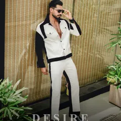 A full-body shot of the black and white color-blocked co-ord set. The sharp contrast and modern design create a visually striking and confident silhouette.