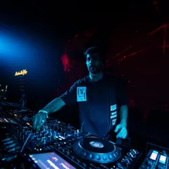 A moment of concentration at the DJ booth. I'm constantly tweaking EQs and effects to shape the sound and keep the energy flowing on the dancefloor.