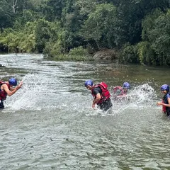 Participants enjoying a splash fight in the calm sections of the Barapole river in Coorg. Our camps balance high-adrenaline activities with moments of pure fun.