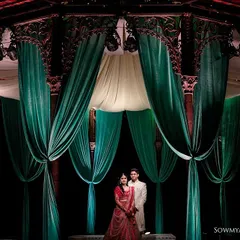 We love playing with light and scale to create dramatic, unforgettable portraits. Here, the grandeur of the decor frames the couple, making them the centerpiece of their own epic love story.