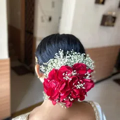 A back view of the beautiful red rose floral bun, showing the volume and intricate placement of the flowers.