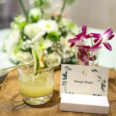 A glass of our signature "Mango Magic" mocktail. This refreshing drink captures the sweet, tropical flavour of mango, making it a perfect choice for a summer event.
