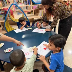 I love guiding the children as they explore different textures and colors. This group finger painting session was full of focus and fun, helping them learn to share materials and work alongside their friends.