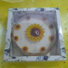 Bring sunshine to your celebrations with our sunflower cake candle. It features a large sunflower on top with smaller ones around the edge, perfect for birthdays and special moments.