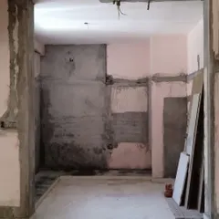 The kitchen and dining area after demolition. By removing the walls, I prepared the space for an open-concept layout with a breakfast counter, completely changing the flow and feel of the home.