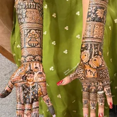 A complete bridal story on both hands. This design features a portrait of the groom on one palm and the couple's initials on the other, surrounded by traditional motifs like peacocks and a kalash.