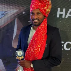 Coach Paresh Shivalkar at the WIFA awards ceremony, dressed in traditional attire with his well-deserved trophy. His leadership and deep knowledge of football inspire our entire academy.