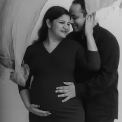 A soft and romantic black and white couple's portrait. The interplay of light, shadow, and the flowing fabric creates a dreamy, fine-art feel, celebrating the couple's intimate connection.