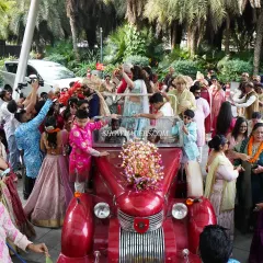The groom's baraat is a full celebration. We organize the procession with elements like a vintage car, music, and plenty of space for dancing.