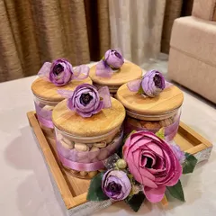 A beautiful Diwali shagun gift for a groom-to-be. This elegant set features decorated jars filled with dry fruits on a wooden tray, perfect for wedding trousseau packing.