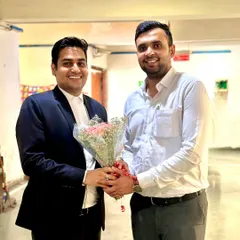 Receiving a bouquet from a colleague, likely during a bar association event. Building good relationships within the legal fraternity is important to me.
