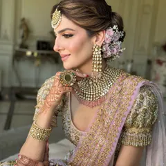 A bridal look is more than just a hairstyle; it's a crown. This soft, textured messy bun, adorned with fresh flowers, is a favorite I teach. It shows how to create volume and romance while ensuring the style is secure and comfortable for a long wedding day.