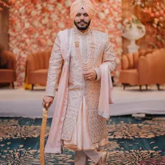 A regal portrait of the groom on his wedding day. We captured his confident stance and magnificent attire to create an image of timeless elegance.