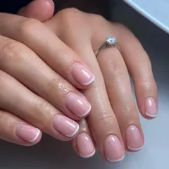 This classic French manicure on short, rounded nails is perfect for everyday elegance. The glossy finish makes the nails look healthy and polished.