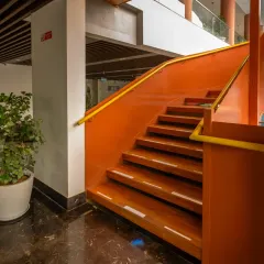 In the Sona Vistaas Clubhouse, this sculptural staircase in terracotta red is not just for circulation. It is a central design element that introduces movement and visual drama, turning a functional component into a piece of art.