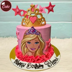 A vibrant pink Barbie cake for a princess-themed party. It features a beautiful illustration of Barbie, a golden tiara topper, and frilly pink icing details.
