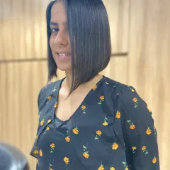 The stunning "after" of a precision bob haircut. The cut is sharp, asymmetrical, and perfectly straight, showcasing a modern and sophisticated style.